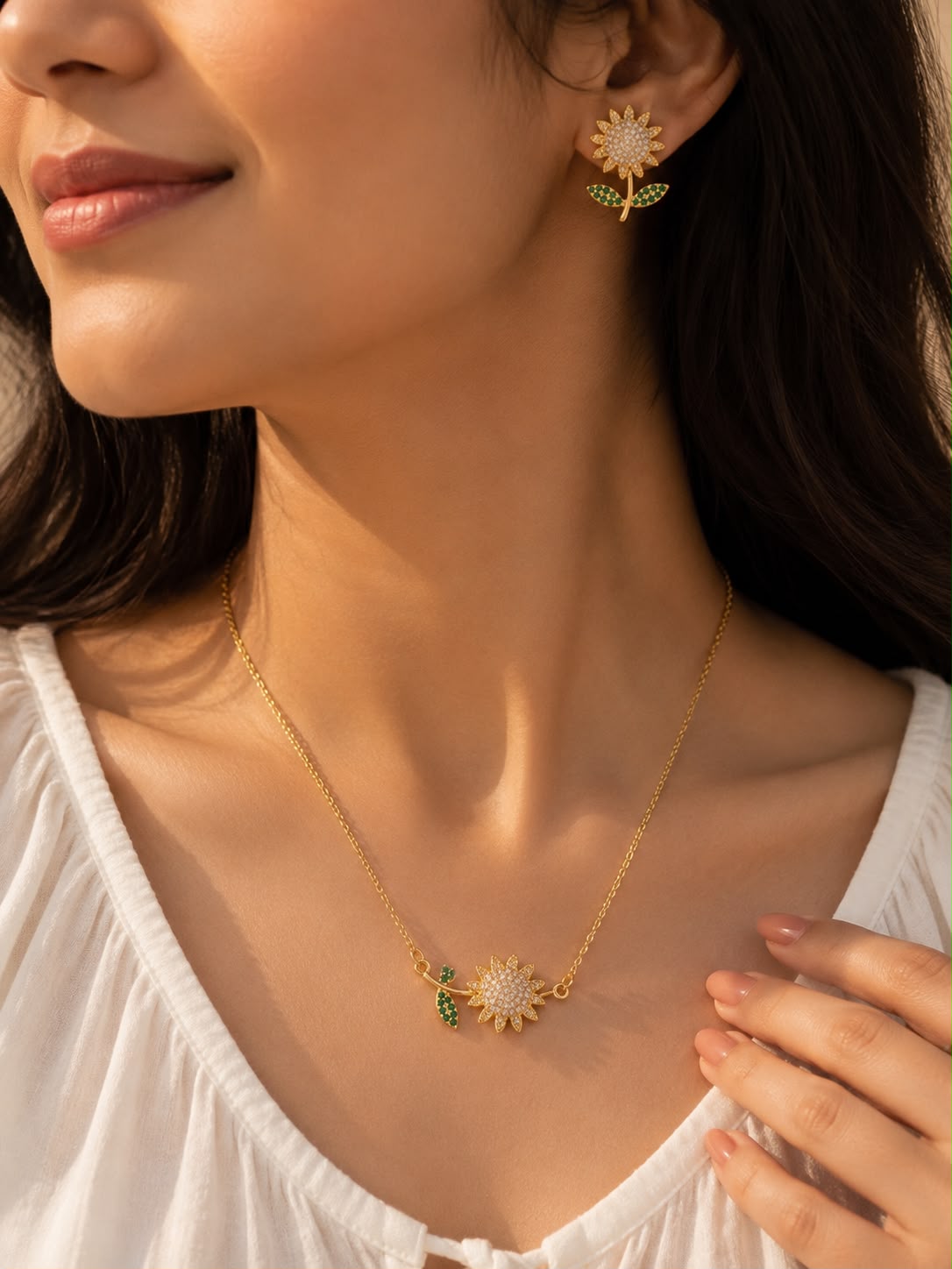 Model wearing sunflower necklace and earrings set in gold tone