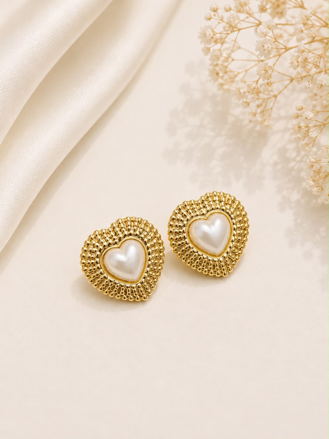 Gold beaded frame pearl heart stud earrings flat lay