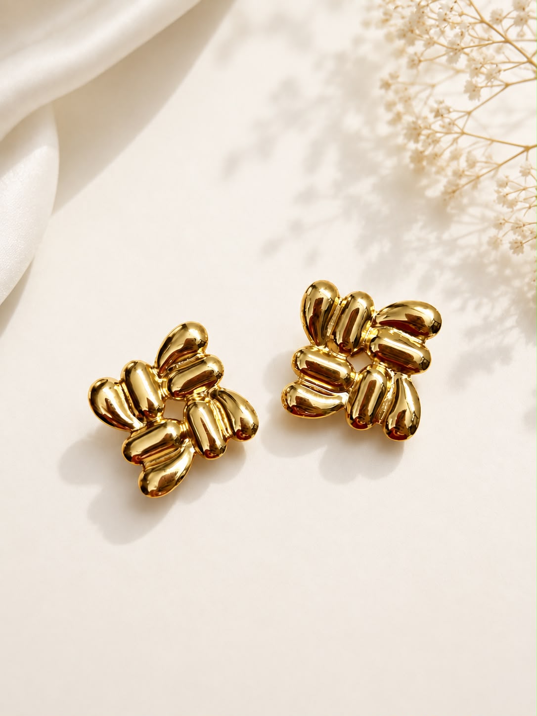 Gold chunky petal cluster stud earrings flat lay