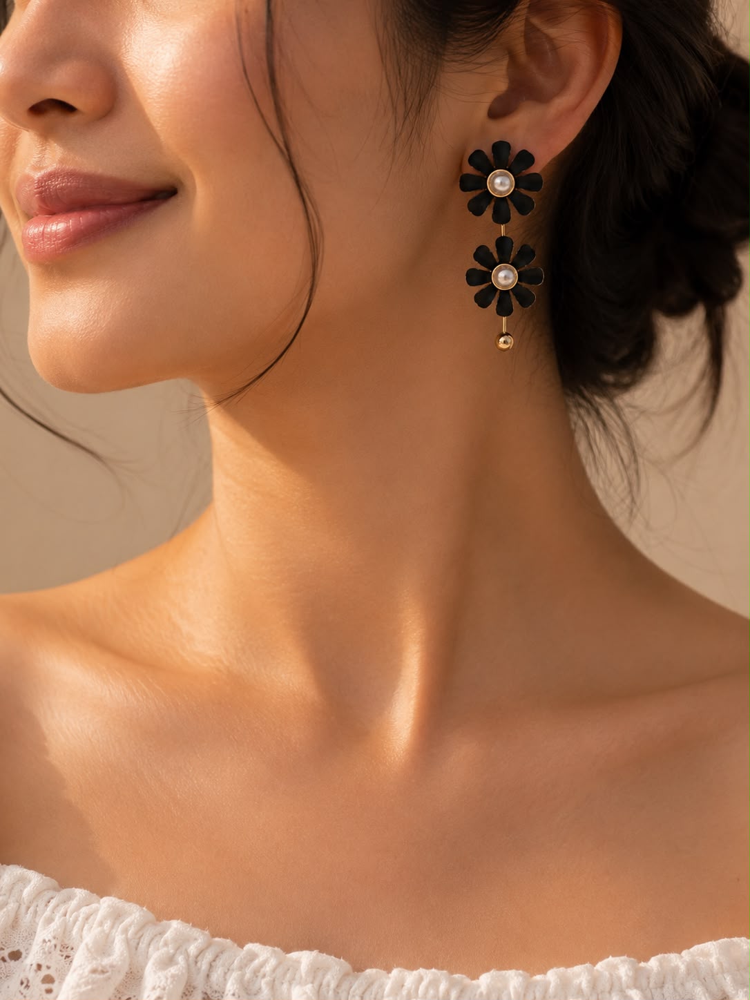 Black daisy double drop earrings worn by model - editorial shot