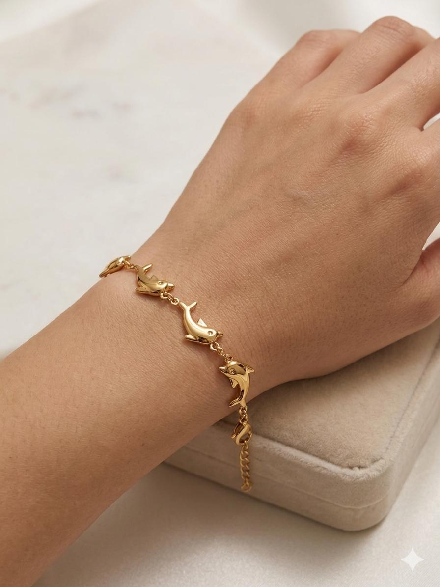 Dolphin Link Bracelet - gold sculpted dolphin links mid-leap
