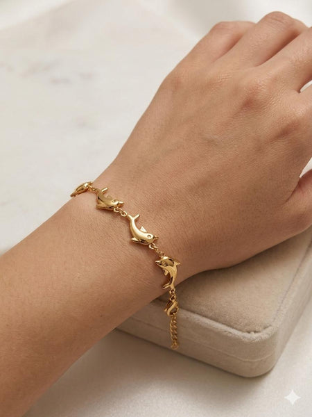 Dolphin Link Bracelet - gold sculpted dolphin links mid-leap