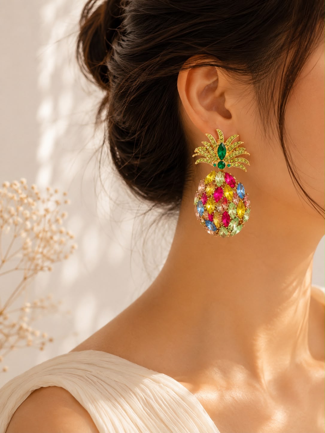 Pineapple crystal earrings on model