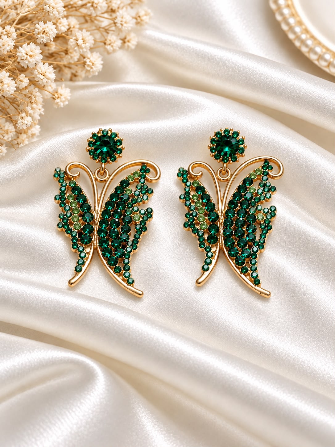 Gold-tone butterfly earrings decorated with green stones
