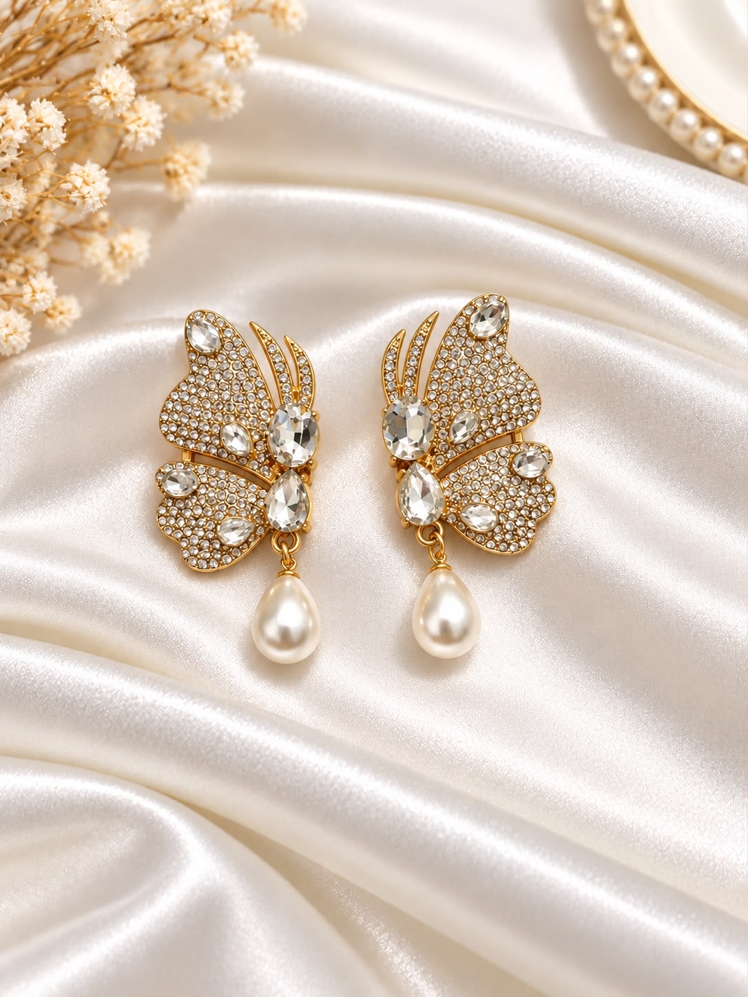 Gold-tone crystal butterfly earrings with pearl-style teardrop accents