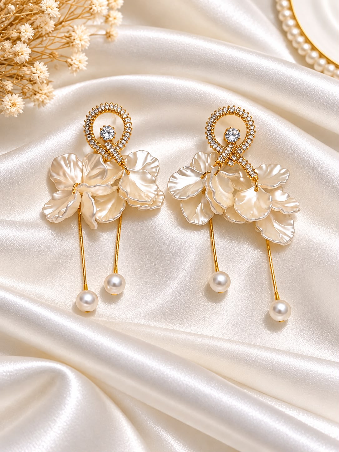 Ivory floral earrings with gold-tone strands and pearl-style drops