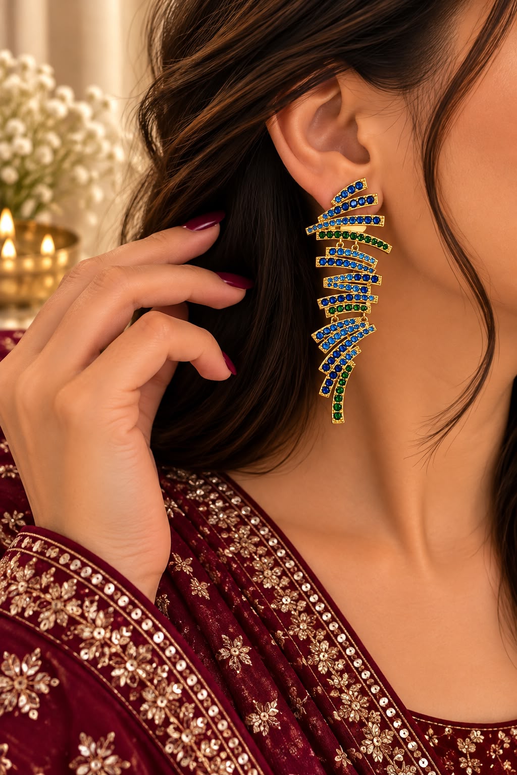 Model wearing blue and green cascade statement earrings