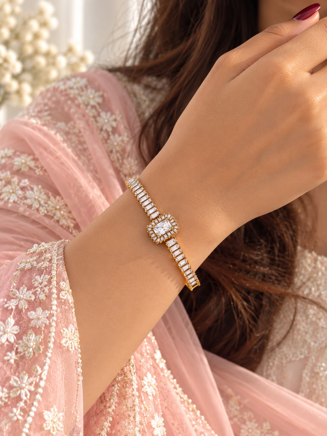 Regalia gold-tone rectangular halo bracelet worn with a pink embroidered outfit