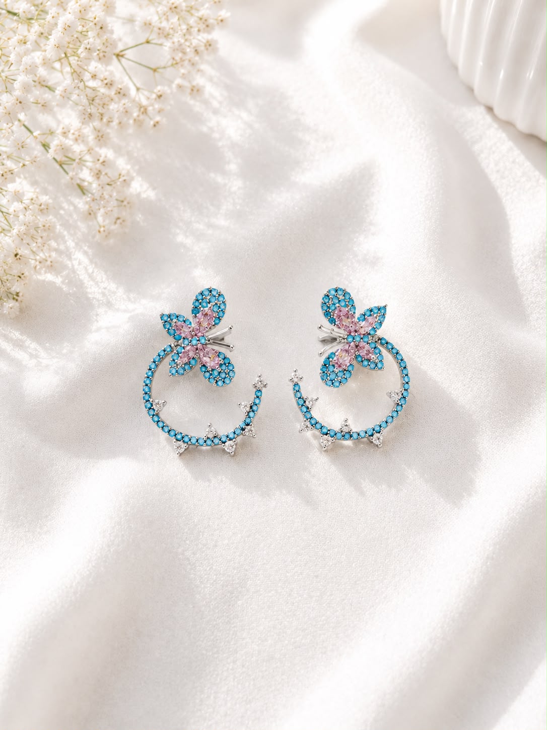 Silver-tone turquoise butterfly hoop earrings with pink crystal wings