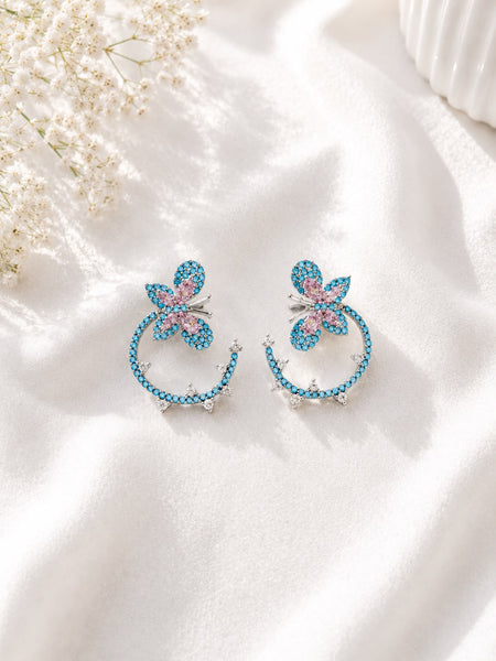 Silver-tone turquoise butterfly hoop earrings with pink crystal wings