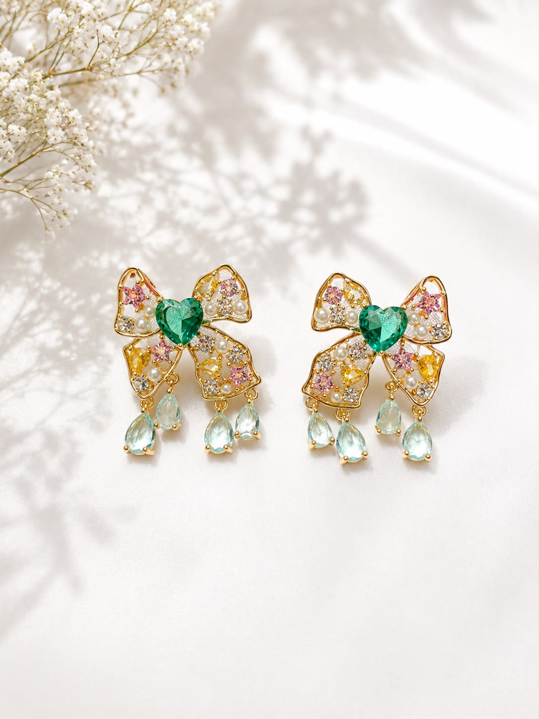 Gold bow earrings with emerald green heart stone, pearls and aqua teardrops